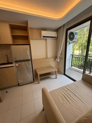 a room with a bed and a kitchen with a window at 1 bedroom in Kamala Beach in Kamala Beach