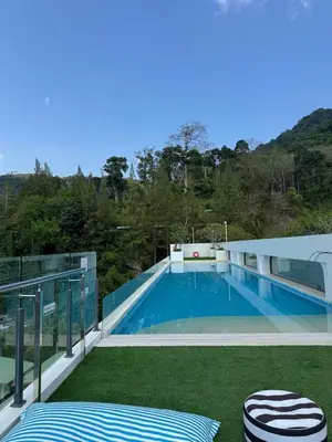 a swimming pool on the balcony of a house at 1 bedroom in Kamala Beach in Kamala Beach