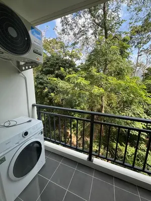 a balcony with a washing machine and a window at 1 bedroom in Kamala Beach in Kamala Beach
