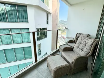 two chairs sitting on the balcony of a building at Studio Sea view with kitchen by Renttini in Kamala Beach