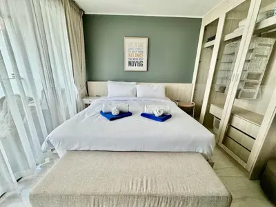 a bedroom with a bed with two towels on it at Studio Sea view with kitchen by Renttini in Kamala Beach