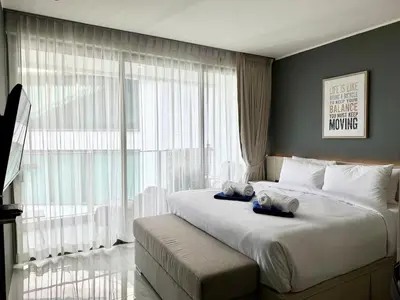 a bedroom with a large bed with a large window at Studio Sea view with kitchen by Renttini in Kamala Beach