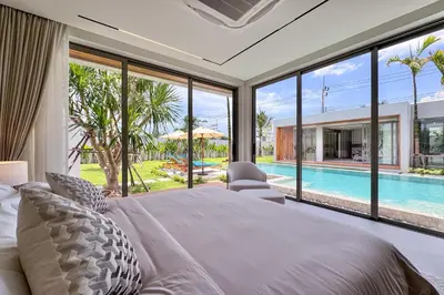 a bedroom with a large bed and a pool at New & Exclusive! Private 4BR Zenithy Luxe Pool Villa near Laguna in Bang Tao Beach