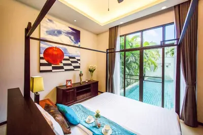 a bedroom with a large bed and a large window at VILLA Emere Private Pool Nai Harn beach in Nai Harn Beach