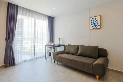 a living room with a couch and a table at Mountain View 1 Bed Apt T2-723 in Chalong