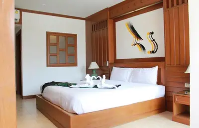 a bedroom with a bed with two swans on it at Cocoon Talya Hotel in Patong Beach