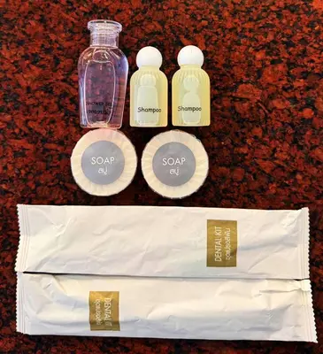 a bottle of soap and a bag on a counter at Cocoon Talya Hotel in Patong Beach