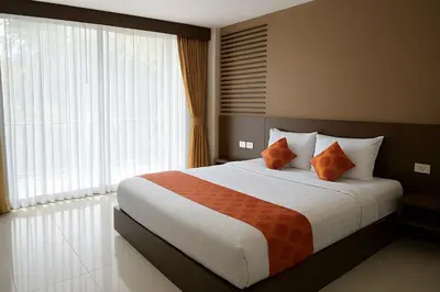 a bedroom with a large bed and a large window at KT8 Hotel AoNang in Ban Khlong Haeng