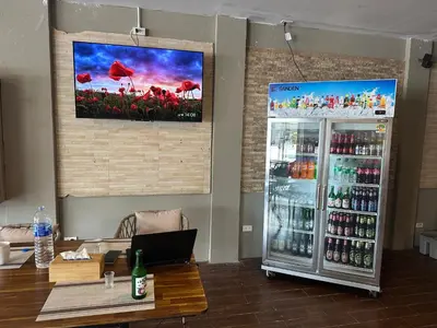 a room with a refrigerator and a table with a laptop at KT8 Hotel AoNang in Ban Khlong Haeng