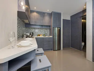 a kitchen with gray cabinets and white counters at Kamala Suite CTG L202, Top Amenities near Cafe del Mar and Fantasea in Kamala Beach