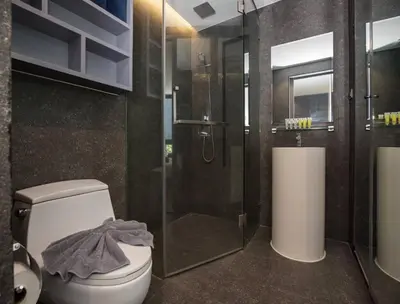 a bathroom with a toilet and a glass shower at Kamala Suite CTG L202, Top Amenities near Cafe del Mar and Fantasea in Kamala Beach