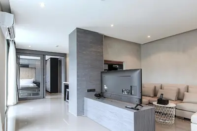 a living room with a large flat screen tv at Citygate 2BR Suite CTG L402-3, Top Facilities, near FantaSea & Café Del Mar Beach Club in Kamala Beach