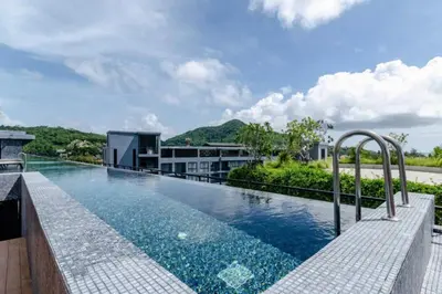 an infinity pool on the roof of a building at Citygate 2BR Suite CTG L402-3, Top Facilities, near FantaSea & Café Del Mar Beach Club in Kamala Beach