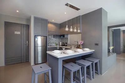 a kitchen with a large island with stools in it at Citygate 2BR Suite CTG L402-3, Top Facilities, near FantaSea & Café Del Mar Beach Club in Kamala Beach