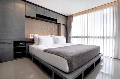 a bedroom with a large bed and a window at Tropics & Modern Stay - Kamala 2BR Suite CTG L502-3, Best Amenities & Beach Fun in Kamala Beach