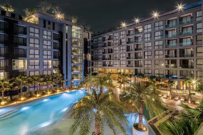 an overhead view of a pool with palm trees in front of buildings at Tropics & Modern Stay - Kamala 2BR Suite CTG L502-3, Best Amenities & Beach Fun in Kamala Beach