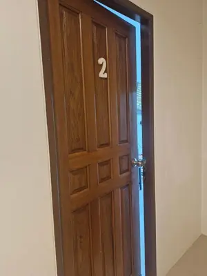 a wooden door with the number two on it at Katika Home 2 in Ban Khlong Haeng