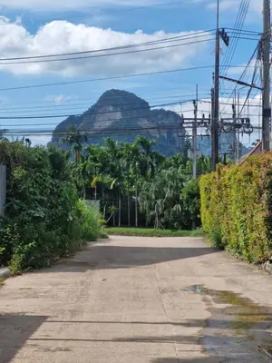 an empty road with a mountain in the background at Katika Home 2 in Ban Khlong Haeng