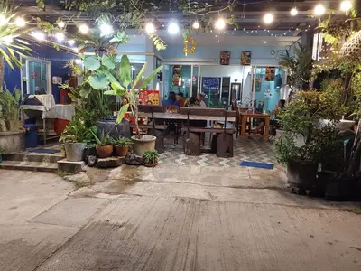 a restaurant with a bunch of plants and a table at Katika Home 2 in Ban Khlong Haeng