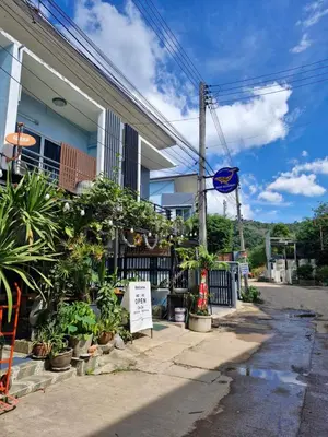 a building with plants on the side of a street at Katika Home 2 in Ban Khlong Haeng