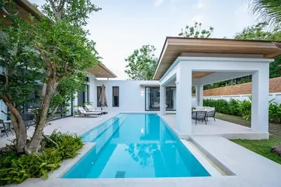 a swimming pool in the backyard of a villa at Mouana Breeze Mai Khao 4-bedroom Pool Villa 9918 in Mai Khao Beach