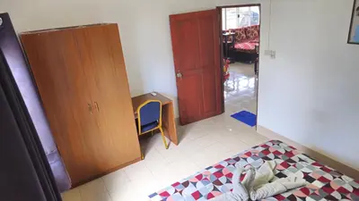 a bedroom with a bed and a cabinet and a chair at Rawai Naiharn 3 bedroom house in Rawai Beach