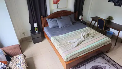 a bedroom with a bed with a wooden headboard at Rawai Naiharn 3 bedroom house in Rawai Beach