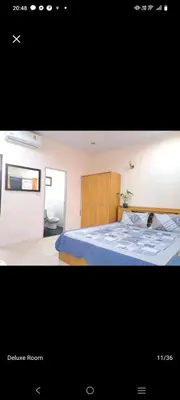 a picture of a bedroom with a blue bed at The Grove Guesthouse in Patong Beach
