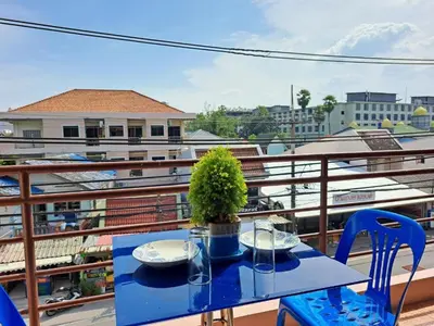 a blue table with a plant on a balcony at The Grove Guesthouse in Patong Beach