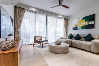 a living room with a couch and a table at Beachfront 2-bd apartment Laguna in Bang Tao Beach