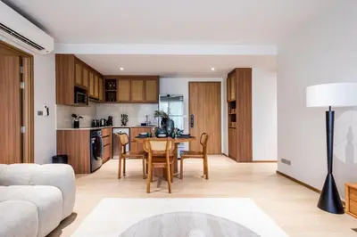 a kitchen and living room with a table and chairs at Beachfront 2-bd apartment Laguna in Bang Tao Beach