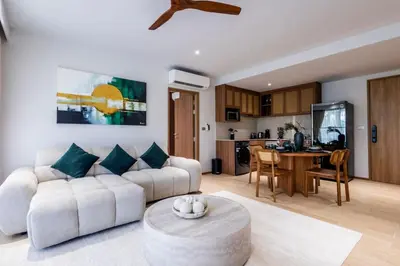 a living room with a couch and a table at Beachfront 2-bd apartment Laguna in Bang Tao Beach
