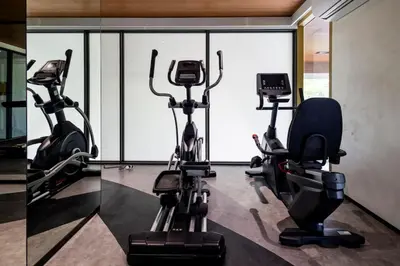 two different views of a gym with exercise bikes at Beachfront 2-bd apartment Laguna in Bang Tao Beach