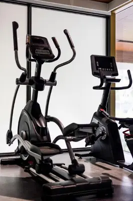 a gym with two exercise bikes and a treadmill at Beachfront 2-bd apartment Laguna in Bang Tao Beach