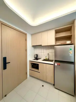 a kitchen with a stainless steel refrigerator and a door at 1-bd apartment on Kamala beach in Kamala Beach