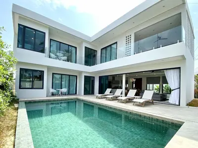 an exterior view of a house with a swimming pool at Rawai Duplex Style Luxurious 4-BR Private Pool Villa in Rawai Beach