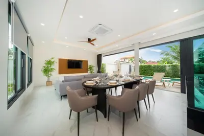 a dining room with a table and chairs at Rawai Duplex Style Luxurious 4-BR Private Pool Villa in Rawai Beach