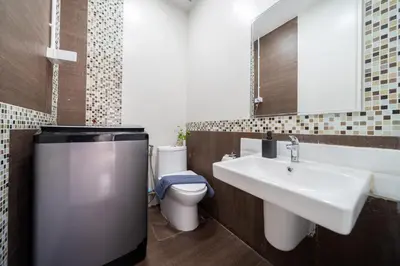 a bathroom with a white sink and a toilet at Duplex Style 3-BR Corner Private Pool Villa in Ban Pak Lak