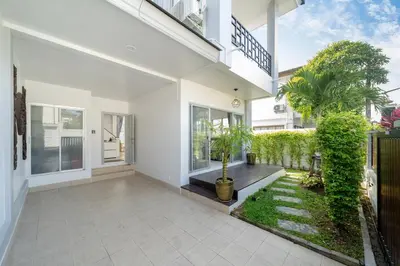 a white house with a courtyard with plants at Duplex Style 3-BR Corner Private Pool Villa in Ban Pak Lak