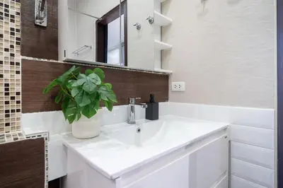a bathroom with a white sink and a mirror at Duplex Style 3-BR Corner Private Pool Villa in Ban Pak Lak