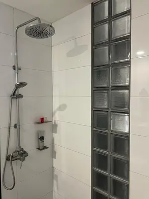 a shower with a glass block wall in a bathroom at Bangtao Beach Gardens in Surin Beach
