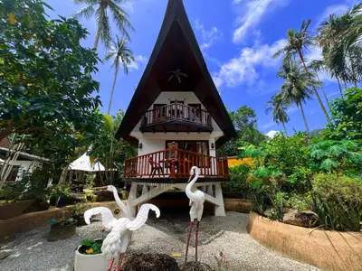 three fake birds in front of a building at Coco palace resort in Rawai Beach