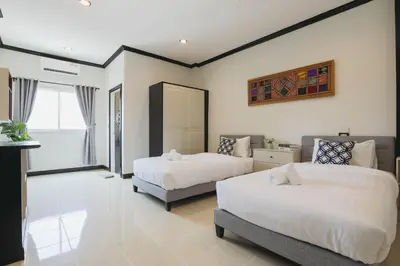 a bedroom with two beds and a window at Wink City 2 Patong Center close to the Beach in Patong Beach