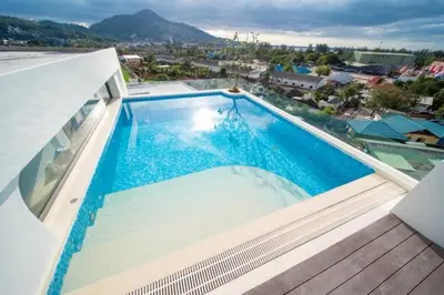 a swimming pool on the roof of a house at now condo near beach 2bedroom in Kamala Beach