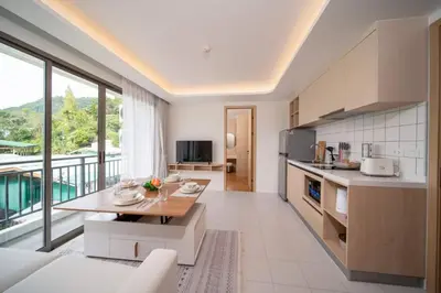 a kitchen with a table and a large window at now condo near beach 2bedroom in Kamala Beach