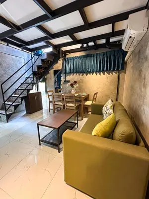 a living room with a couch and a table at Water Lily Spa Bungalows by Rawai Beach in Rawai Beach