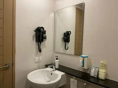 a bathroom with a sink and a mirror at The Rock Patong Comfort Stay in Patong Beach