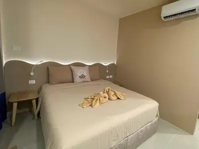 a bedroom with a bed with bananas on it at The Rock Patong Comfort Stay in Patong Beach