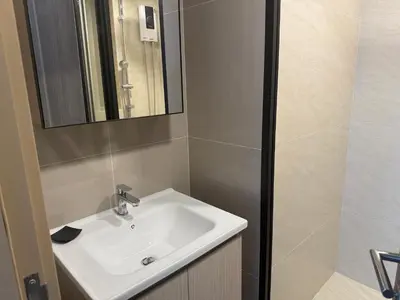 a bathroom with a white sink and a mirror at THE BASE Rise Resort Style 1 & 2 Bedrooms in Ban Rangeng