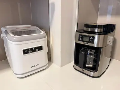 a coffee maker and a coffee machine in a refrigerator at THE BASE Rise Resort Style 1 & 2 Bedrooms in Ban Rangeng